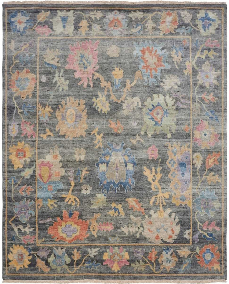 Traditional oriental area rug with a dark smoke-grey field featuring vibrant floral blossoms in coral, azure blue, mustard gold, and soft lavender.