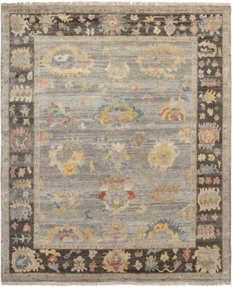 Traditional oriental rug with a muted grey flannel field, a dark bark-brown border, and colorful distressed floral motifs.